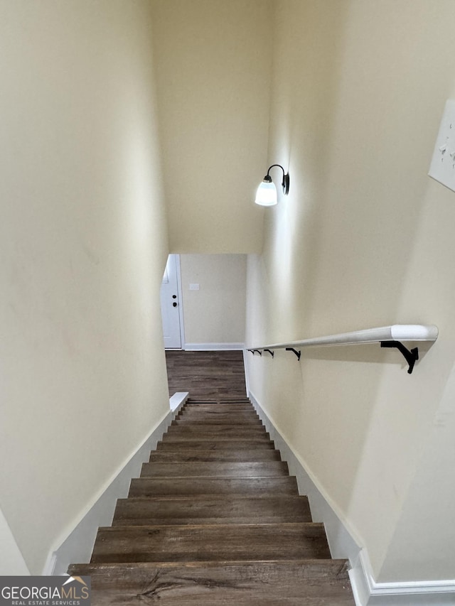 stairs with wood-type flooring