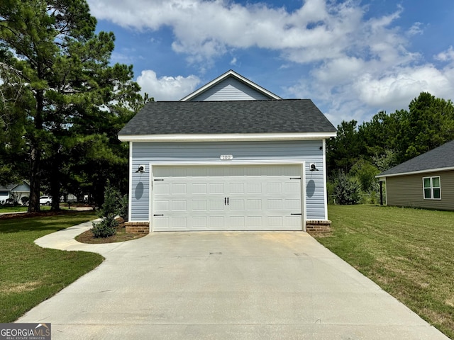 garage featuring a lawn