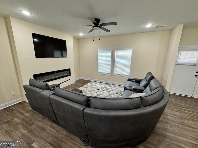 living room featuring dark hardwood / wood-style floors and ceiling fan