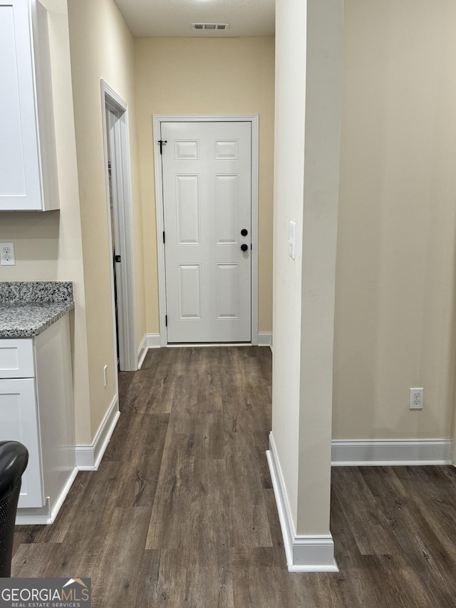 hall with dark wood-type flooring