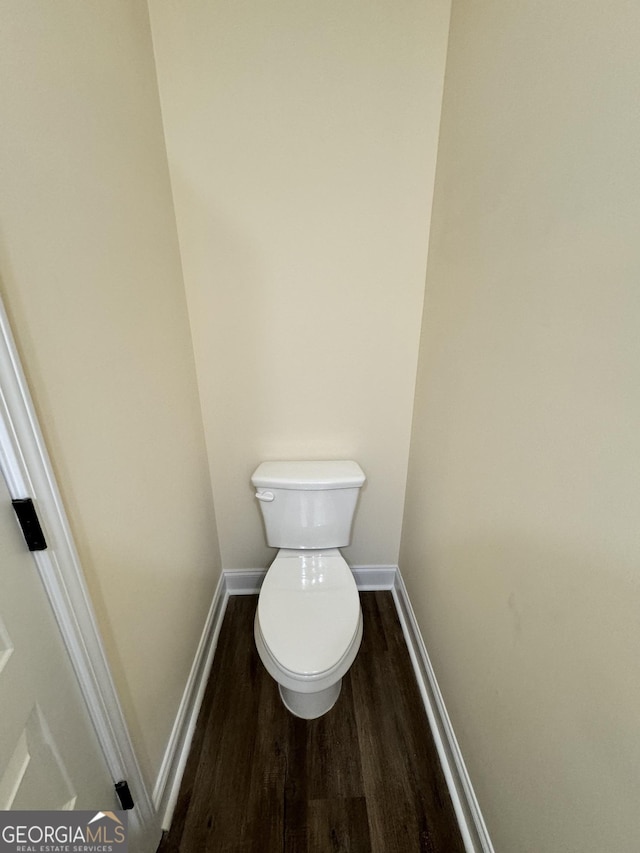 bathroom featuring hardwood / wood-style floors and toilet