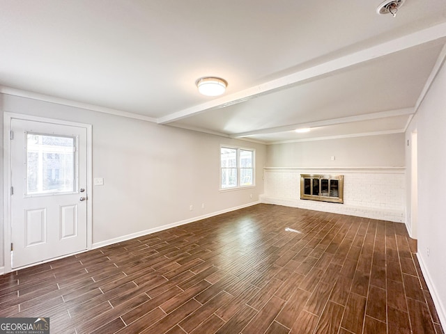 unfurnished living room with beam ceiling and a fireplace