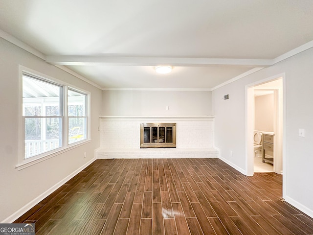 unfurnished living room with crown molding, a fireplace, and beamed ceiling