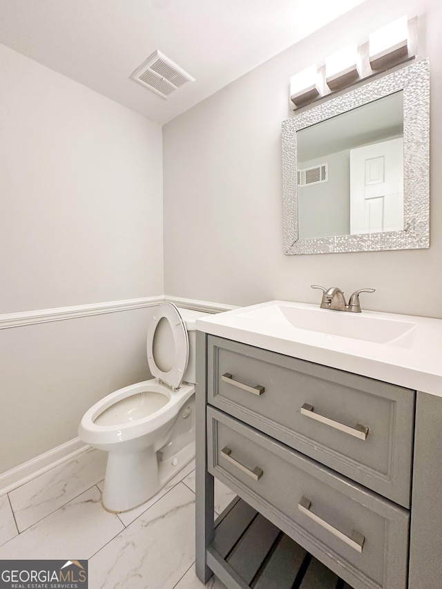 bathroom with vanity and toilet