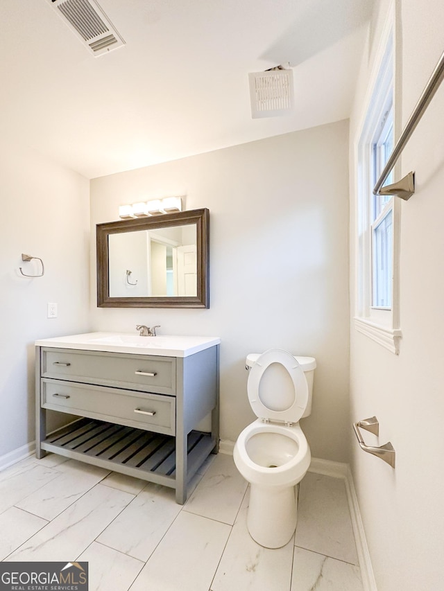 bathroom with vanity and toilet