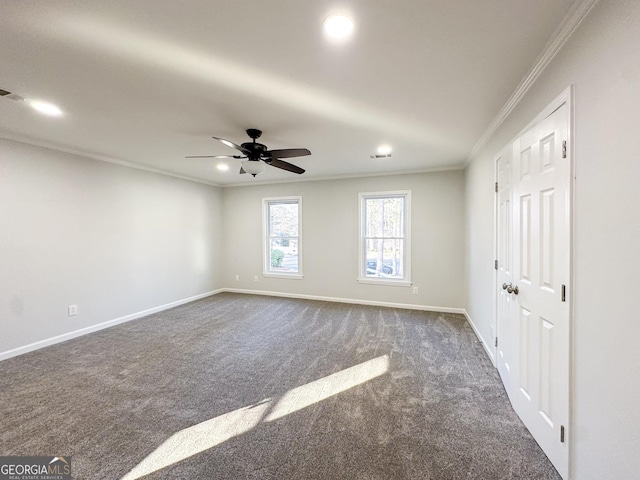 carpeted spare room featuring crown molding and ceiling fan