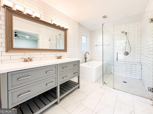 bathroom with ceiling fan, tile walls, backsplash, vanity, and separate shower and tub