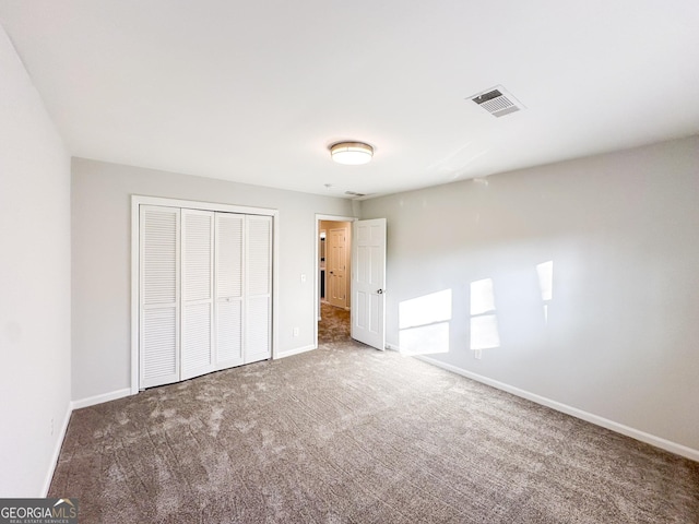 unfurnished bedroom with carpet floors and a closet