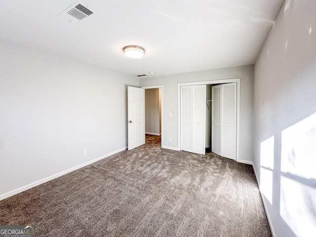 unfurnished bedroom with carpet floors and a closet