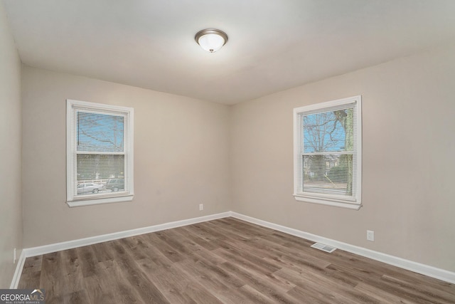 empty room featuring wood-type flooring