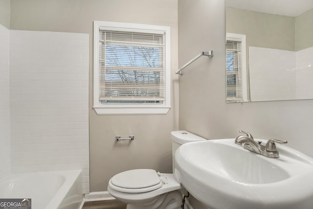 full bathroom featuring tub / shower combination, sink, hardwood / wood-style floors, and toilet