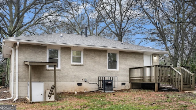 rear view of house featuring central AC unit and a deck