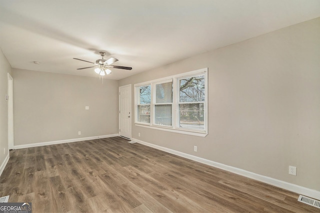 empty room featuring hardwood / wood-style flooring and ceiling fan