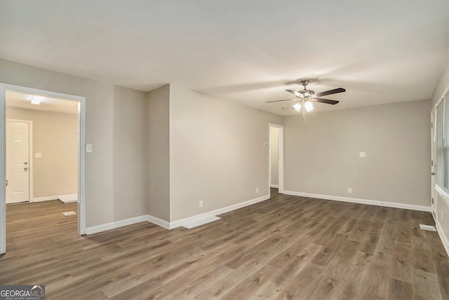 empty room featuring ceiling fan and dark hardwood / wood-style floors