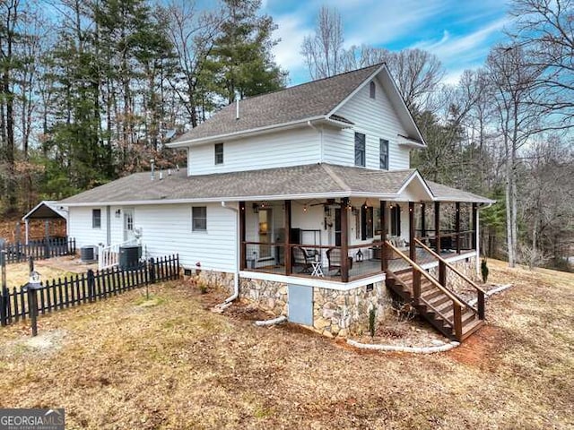 view of front of property with central AC unit, a sunroom, and ceiling fan