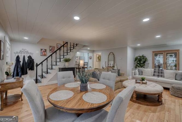 dining space with wood ceiling and light hardwood / wood-style flooring