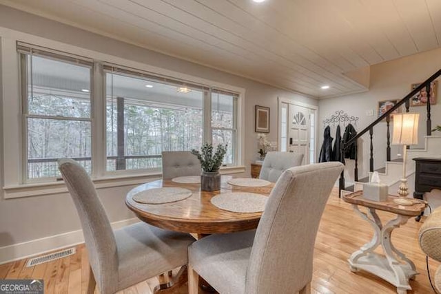 dining area featuring wood ceiling and light hardwood / wood-style flooring