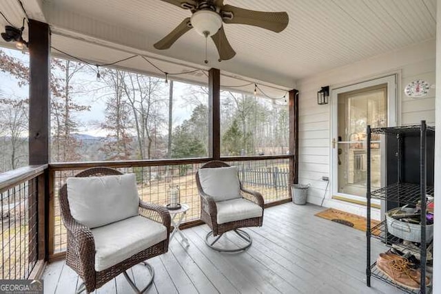 sunroom featuring ceiling fan