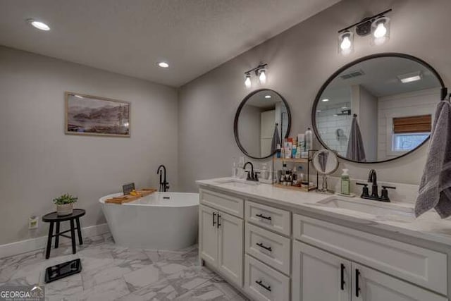 bathroom featuring vanity and a tub to relax in