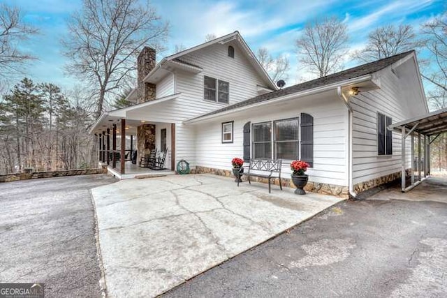 back of property with a porch