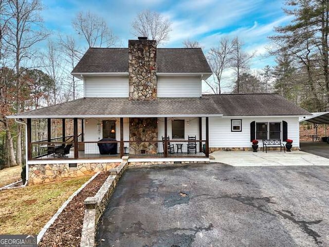 view of front facade with a porch and a carport