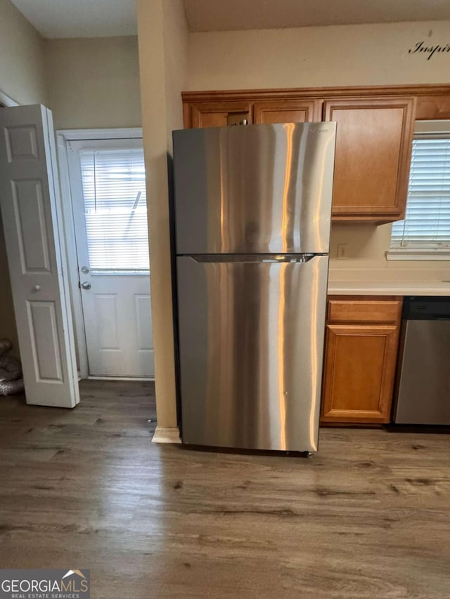 kitchen featuring appliances with stainless steel finishes and light hardwood / wood-style floors