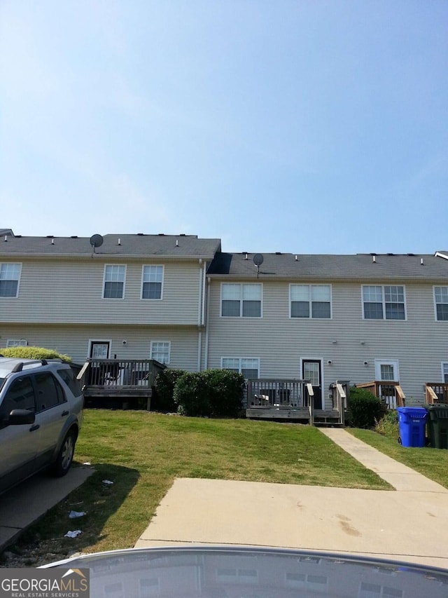 back of house with a yard and a deck