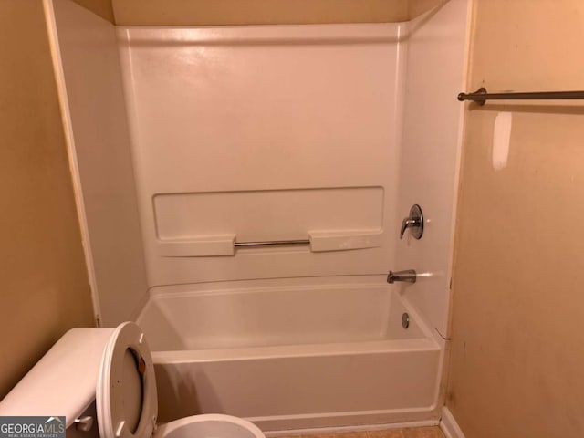 bathroom featuring toilet and shower / bathing tub combination