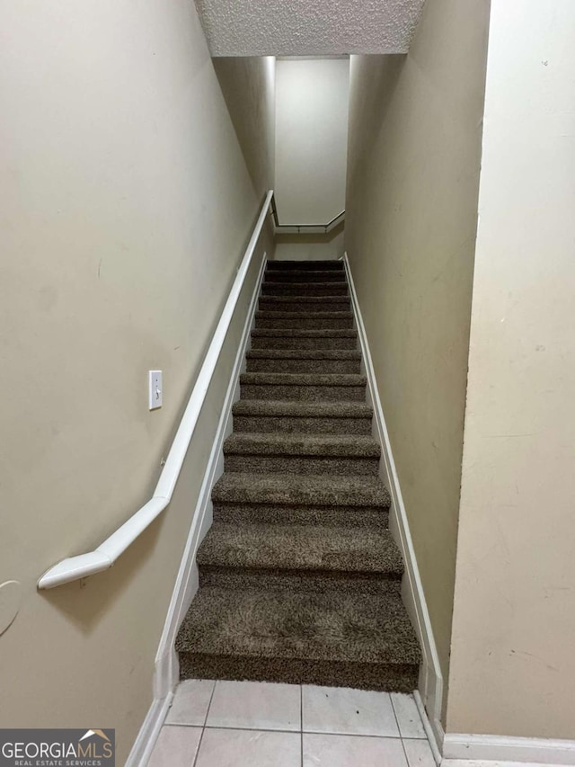 staircase with tile patterned floors