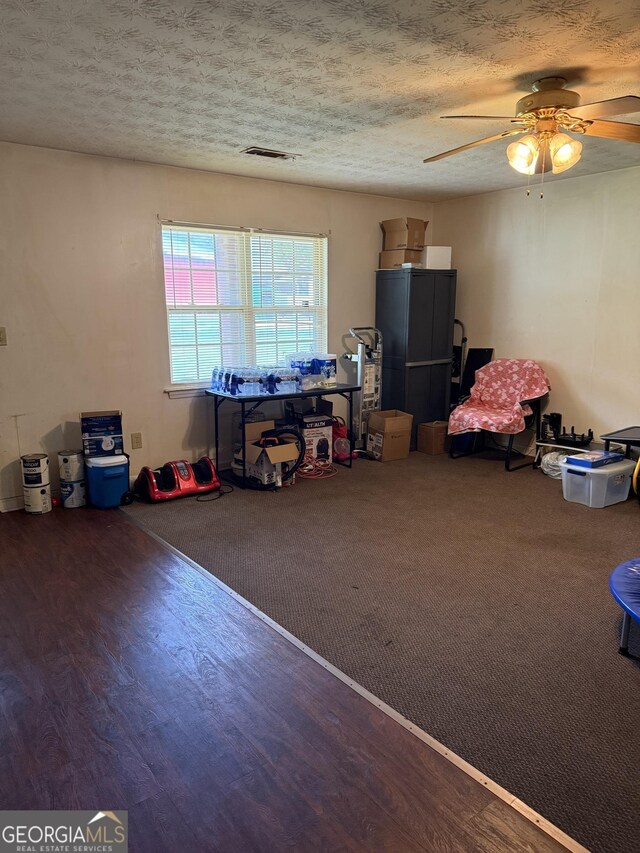 241 E Ash St, Social Circle, GA 30025 - rec room featuring wood finished floors, ceiling fan, visible vents, and a textured ceiling
