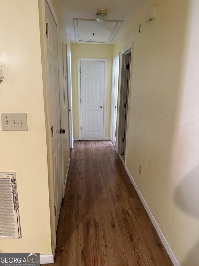 hallway with dark hardwood / wood-style floors