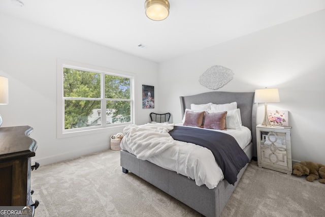 bedroom featuring light colored carpet