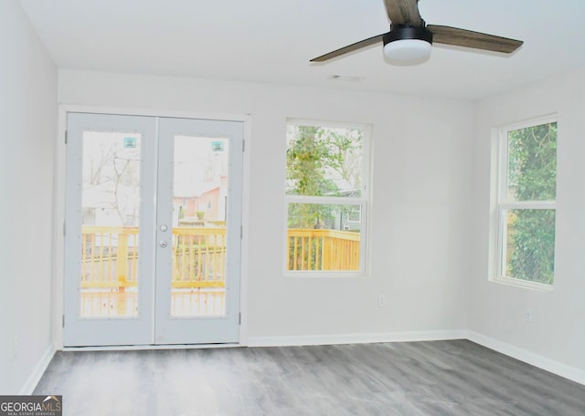 interior space with plenty of natural light, french doors, baseboards, and wood finished floors