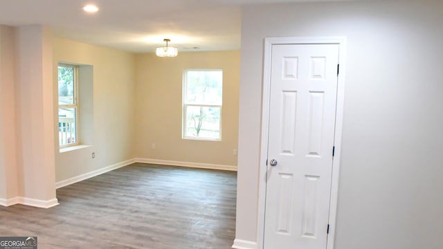 unfurnished room with recessed lighting, baseboards, and dark wood-type flooring