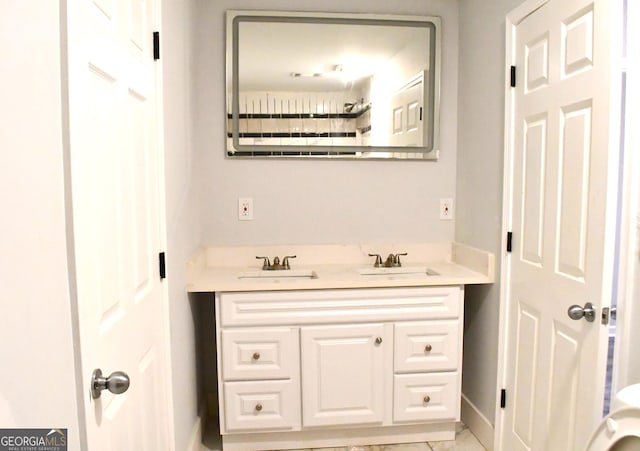 full bath with vanity and baseboards