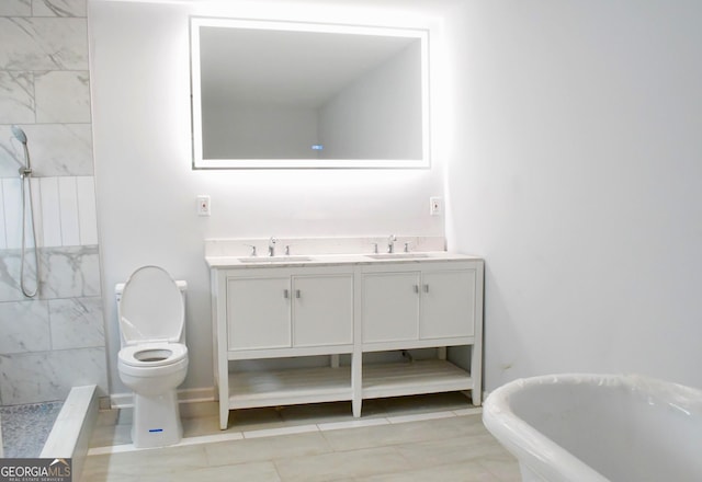 full bathroom with double vanity, toilet, tiled shower, and a sink