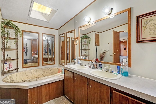 bathroom with ornamental molding, vanity, vaulted ceiling with skylight, and a tub