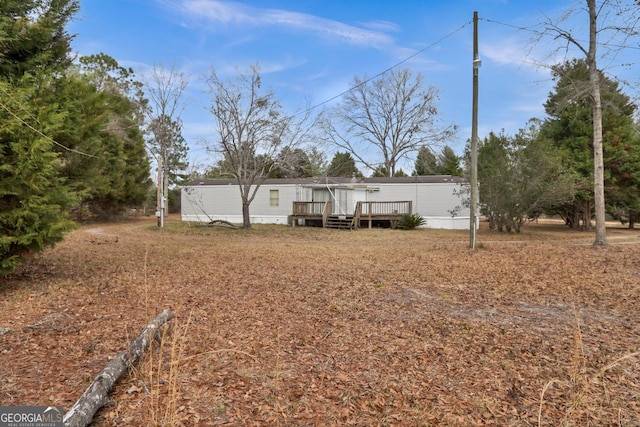 rear view of property featuring a deck