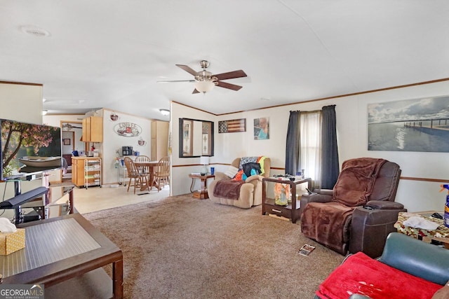 carpeted living room featuring crown molding, vaulted ceiling, and ceiling fan