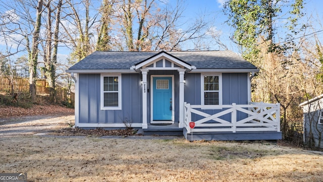 view of front of house featuring board and batten siding and roof with shingles