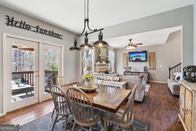 dining space featuring dark hardwood / wood-style floors, ceiling fan, and french doors