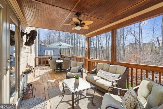 wooden deck featuring ceiling fan and outdoor lounge area