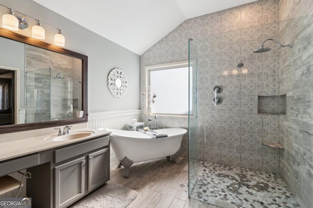 bathroom featuring lofted ceiling, independent shower and bath, hardwood / wood-style floors, and vanity