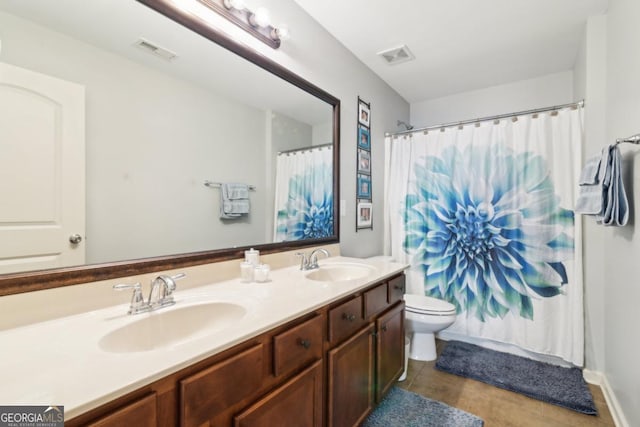 bathroom with a shower with curtain, tile patterned floors, vanity, and toilet