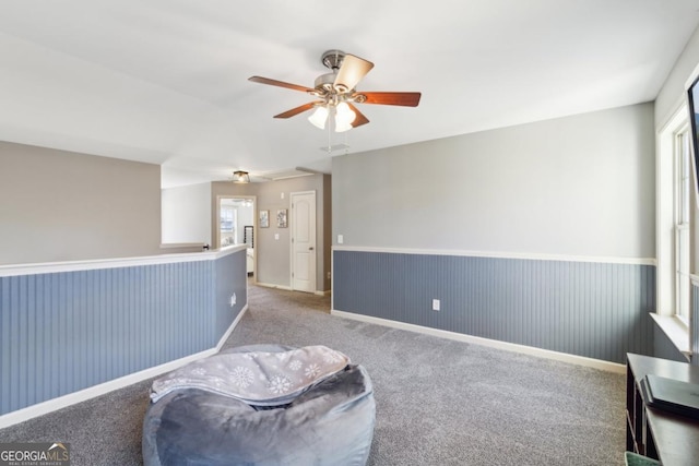 sitting room with carpet floors and ceiling fan