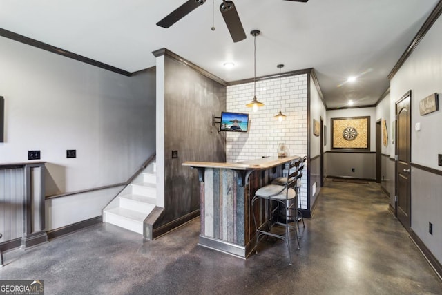 bar featuring hanging light fixtures, ornamental molding, and ceiling fan