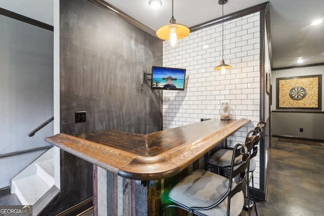 bar featuring ornamental molding and decorative light fixtures