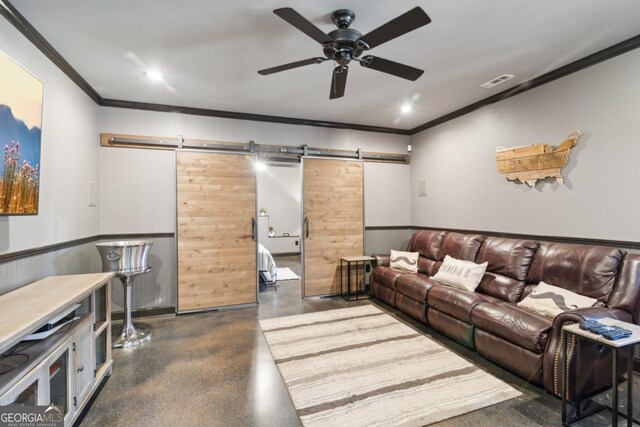 living room featuring crown molding, ceiling fan, and a barn door