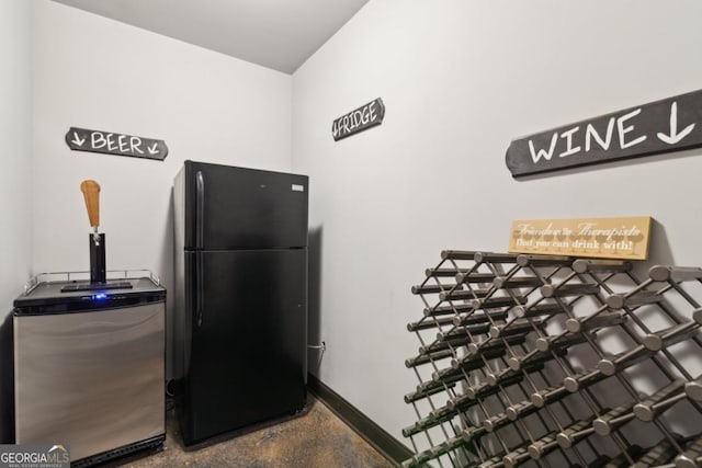 interior space featuring stainless steel refrigerator and black fridge