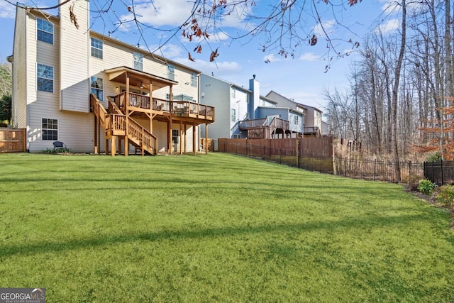 back of property with a wooden deck and a lawn